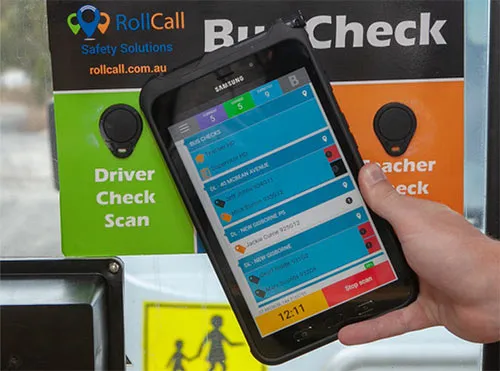 Student tapping NFC card on RollCall device