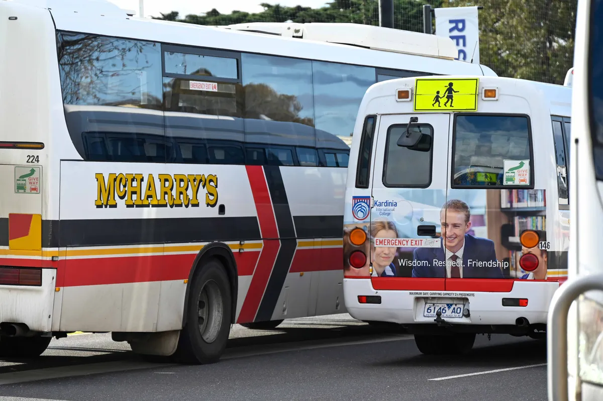 A McHarry's coach and a Kardinia International College bus in the school's bus bays